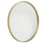 Eleganckie lustro okrągłe 80 cm z metalową złotą ramą, oparte o ścianę w industrialnym wnętrzu z drewnianym wykończeniem.